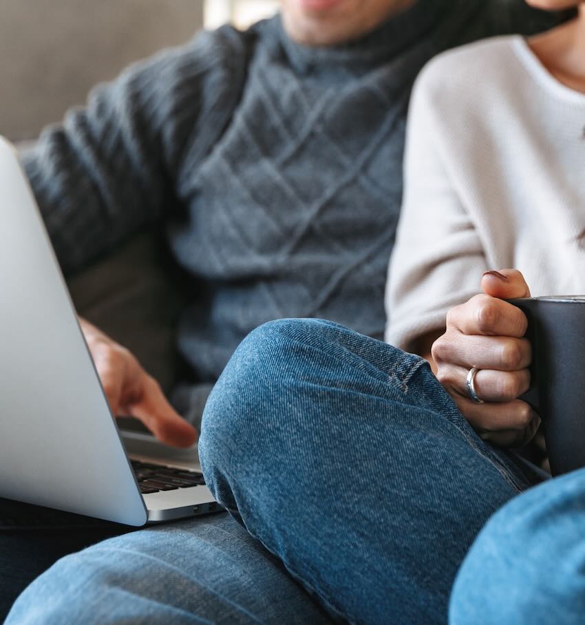 Close up of a couple using a laptop together 